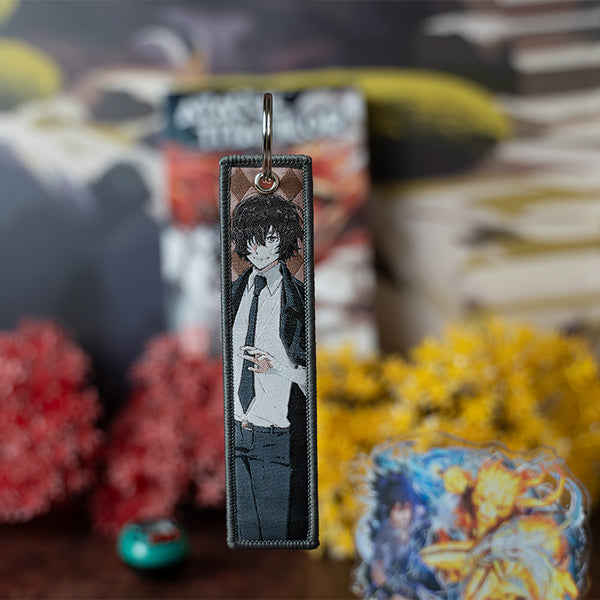 Sleek Bungo Stray Dogs Embroidered Jet Tag featuring high-quality stitching of Atsushi, Dazai, and Akutagawa. Made from durable materials, this double-sided jet tag brings the mystery and intensity of the series to life. Perfect for keys, backpacks, or adding flair to your car, it's a must-have collectible for any Bungo Stray Dogs fan!