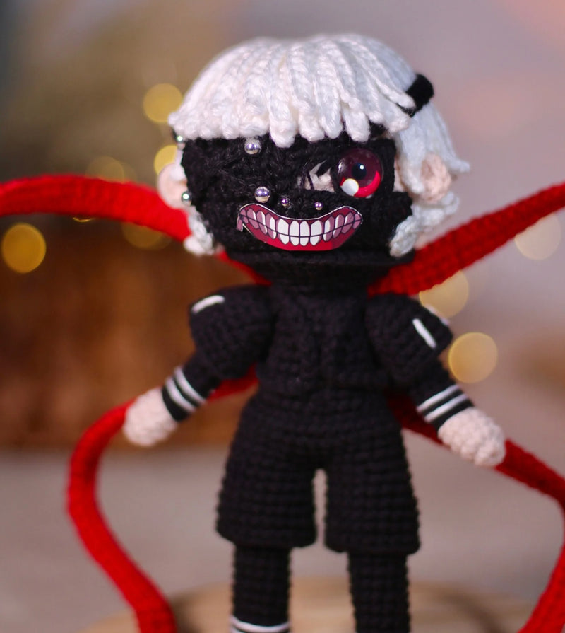 Handmade Tokyo Ghoul Ken Kaneki crochet doll, featuring intricate details inspired by the iconic anime character. This 10–12 inch (25–30 cm) doll showcases Ken's signature black outfit, white hair, and mask, making it a perfect collectible or gift for Tokyo Ghoul fans. Ideal for birthdays, holidays, or as a unique addition to any anime merchandise collection. Crafted with high-quality yarn, this doll is both durable and adorable, a must-have for anime enthusiasts and collectors.