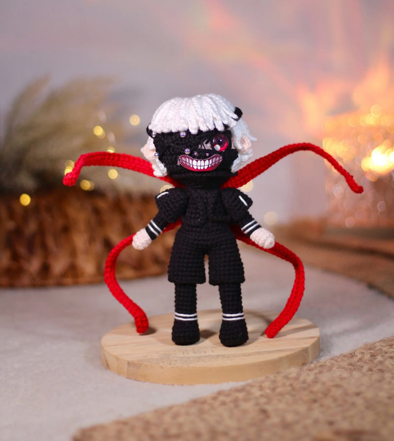 Handmade Tokyo Ghoul Ken Kaneki crochet doll, featuring intricate details inspired by the iconic anime character. This 10–12 inch (25–30 cm) doll showcases Ken's signature black outfit, white hair, and mask, making it a perfect collectible or gift for Tokyo Ghoul fans. Ideal for birthdays, holidays, or as a unique addition to any anime merchandise collection. Crafted with high-quality yarn, this doll is both durable and adorable, a must-have for anime enthusiasts and collectors.