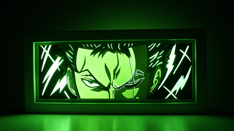 Custom One Piece light box with 3D paper carving and RGB LED lights featuring Roronoa Zoro. Perfect for anime gifts, Christmas decor, and Zoro fans. Remote-controlled colors create a fierce, determined ambiance for any space. Ideal for holidays, birthdays, or special occasions, celebrating Zoro’s swordsmanship, loyalty, and quest to become the world’s greatest swordsman. A must-have for One Piece fans.