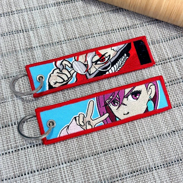 Dandadan jet tag embroidered keychain – premium anime merch featuring high-quality embroidery with bold designs inspired by the hit manga Dandadan. Showcasing iconic characters like Okarun, Momo Ayase, and Turbo Granny, this durable and lightweight keychain is perfect for anime fans, cosplay enthusiasts, and manga collectors. Use it as a bag tag, keychain accessory, or a unique anime gift. Elevate your Otaku collection with this Dandadan jet tag keychain today!