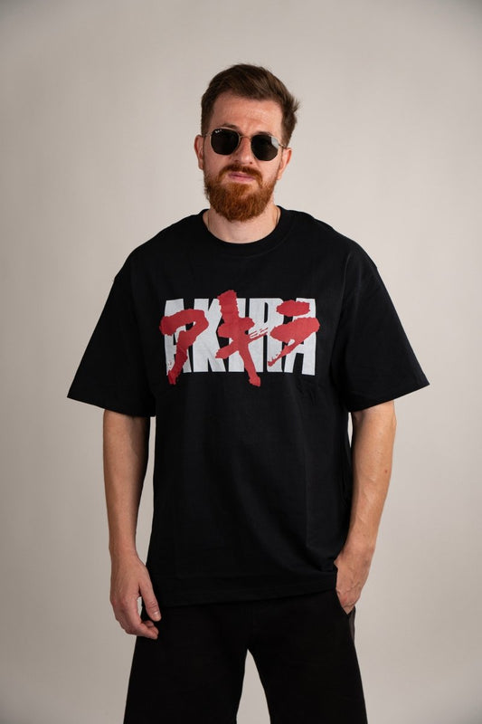 Akira anime vintage graphic T-shirt front view featuring Kaneda iconic motorcycle bike slide scene inspired by the classic Akira film and Neo-Tokyo cyberpunk aesthetic on washed cotton shirt