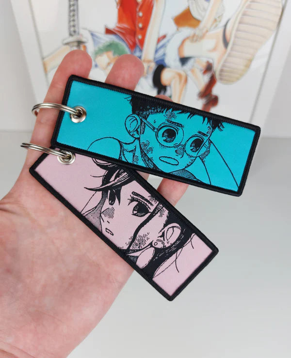 Dandadan embroidered jet tag keychain, Okarun key tag, Momo Ayase anime keychain, Yukinobu Tatsu manga accessory, Japanese anime key tag, otaku embroidered keychain, anime merch gift, Harajuku streetwear accessory, Tokyo street fashion keychain, aesthetic anime jet tag, cosplay bag charm, anime convention accessory, manga collector gift, JDM style embroidered tag, luggage tag, keyring for anime fans, Dandadan cosplay prop.