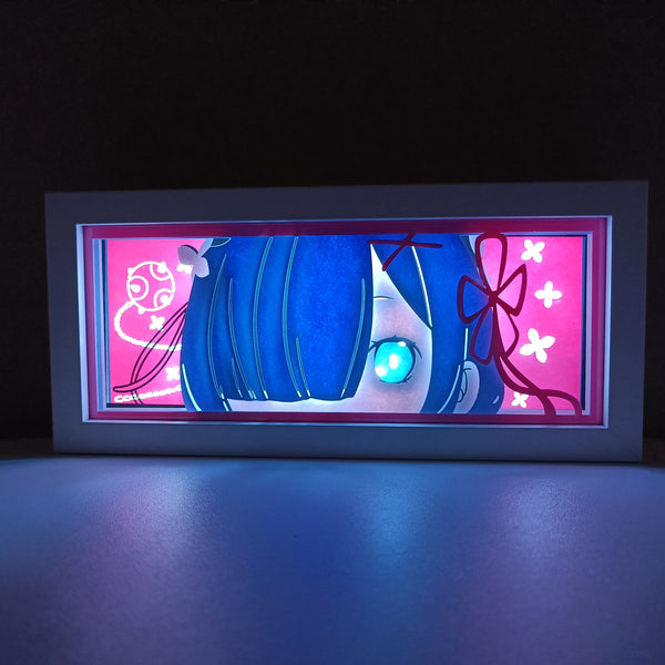 Custom Rezero light box with 3D paper carving and RGB LED lights featuring Subaru, Emilia, Rem, and Ram. Perfect for anime gifts, Christmas decor, and Rezero fans. Remote-controlled colors create a captivating, fantasy-themed ambiance for any space. Ideal for holidays, birthdays, or special occasions, celebrating Subaru’s time loops, Emilia’s magical powers, Rem’s fierce loyalty, and Ram’s sharp wit. A must-have for Rezero fans and collectors of isekai anime, dark fantasy, and unforgettable characters.