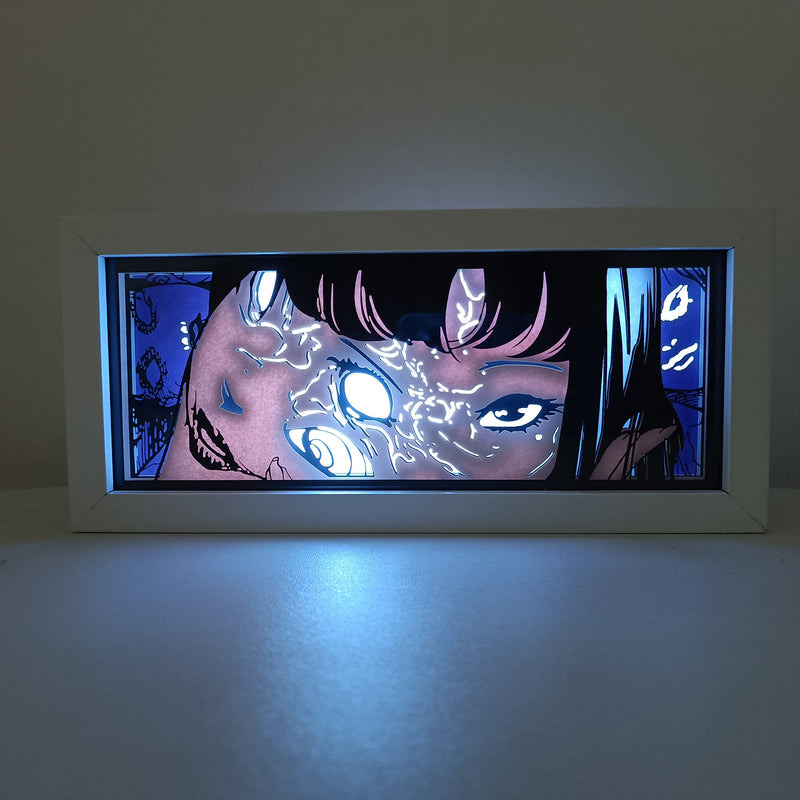 Custom Junji Ito light box with 3D paper carving and RGB LED lights featuring iconic imagery from Uzumaki and Tomie. Perfect for horror fans, anime gifts, and creepy decor. Remote-controlled colors create an eerie ambiance for any space. Ideal for holidays, birthdays, or Halloween, celebrating Junji Ito’s psychological horror and haunting visuals. A must-have for Japanese horror manga fans and collectors.