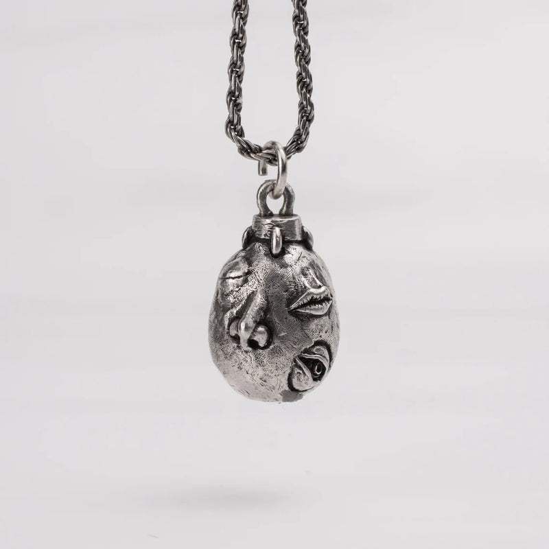 Handcrafted Behelit Jewelry – Berserk-inspired pendant necklace featuring Guts, Griffith, and God Hand symbolism with double-sided design: awakened face and sleeping face. High-quality pewter, hand-cast, unique imperfections, 22-inch (55.9 cm) stainless steel ball chain, secure lobster claw closure. Perfect for Berserk fans, anime collectors, dark fantasy lovers, cosplay, and unique gifts. Symbolic, collectible, artisan design.