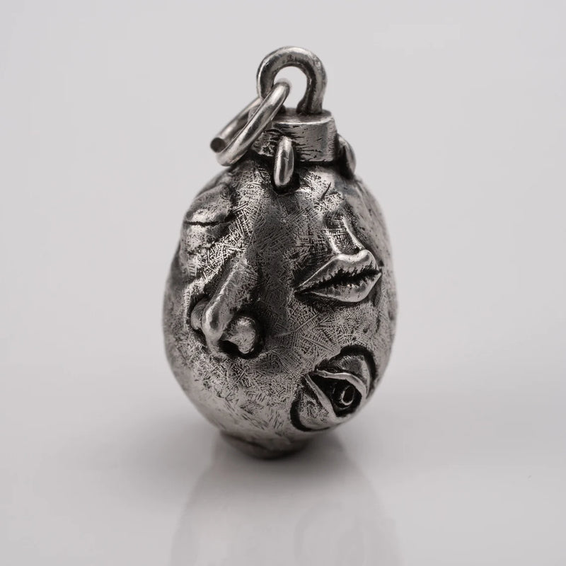 Handcrafted Behelit Jewelry – Berserk-inspired pendant necklace featuring Guts, Griffith, and God Hand symbolism with double-sided design: awakened face and sleeping face. High-quality pewter, hand-cast, unique imperfections, 22-inch (55.9 cm) stainless steel ball chain, secure lobster claw closure. Perfect for Berserk fans, anime collectors, dark fantasy lovers, cosplay, and unique gifts. Symbolic, collectible, artisan design.