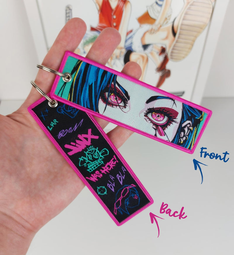 Arcane Embroidered Jet Tag featuring Jinx, Vi, and the Hextech Crystal symbol. Crafted with durable, high-quality materials and bold, double-sided embroidery, this jet tag captures the vibrant energy and dramatic themes of Arcane: League of Legends. Perfect for keys, backpacks, or cars, this collectible is a must-have for fans of Jinx and Vi’s tumultuous journey through Piltover and Zaun. A stylish and practical keepsake for Arcane enthusiasts and gaming fans alike, celebrating the unforgettable bond