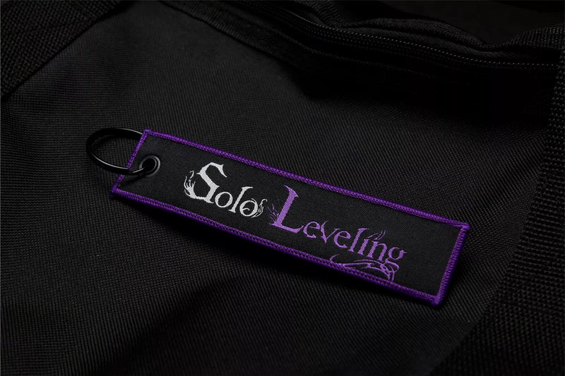 Solo Leveling: Ore dake Level Up na Ken Embroidered Jet Tag featuring Chibi Sung Jin-Woo, the Shadow Monarch symbol, and his iconic dual daggers. Crafted from durable, high-quality materials with bold, double-sided embroidery, this jet tag perfectly captures the intense action and dark fantasy of Solo Leveling. Perfect for keys, backpacks, or cars, this collectible is a must-have for fans of Sung Jin-Woo’s journey and anime enthusiasts who love epic leveling-up stories. Show off your love for Solo Leveling