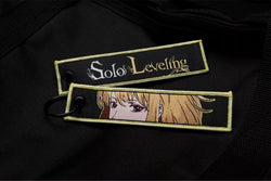 Solo Leveling: Ore dake Level Up na Ken Embroidered Jet Tag featuring Cha Hae-In, the Shadow Monarch symbol, and his iconic dual daggers. Crafted from durable, high-quality materials with bold, double-sided embroidery, this jet tag perfectly captures the intense action and dark fantasy of Solo Leveling. Perfect for keys, backpacks, or cars, this collectible is a must-have for fans of Sung Jin-Woo’s journey and anime enthusiasts who love epic leveling-up stories. Show off your love for Solo Leveling